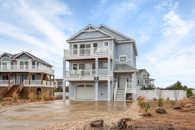 view of front of property featuring a balcony and a garage