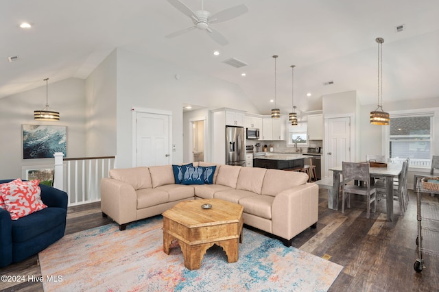 living room featuring ceiling fan, dark wood-type flooring, and high vaulted ceiling