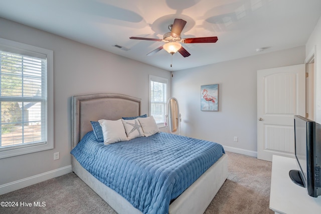 bedroom featuring ceiling fan and light carpet