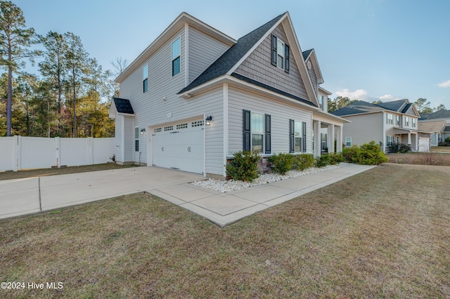 view of side of home featuring a yard and a garage