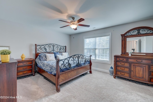 bedroom with light carpet and ceiling fan