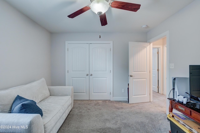 sitting room featuring light colored carpet and ceiling fan