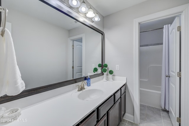 bathroom with tile patterned flooring, vanity, and shower / bath combo with shower curtain