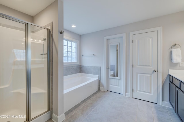 bathroom with plus walk in shower, vanity, and tile patterned floors