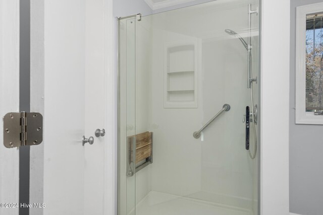 bathroom with a shower with door