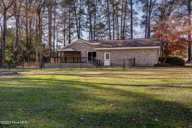 exterior space with a yard and a wooden deck