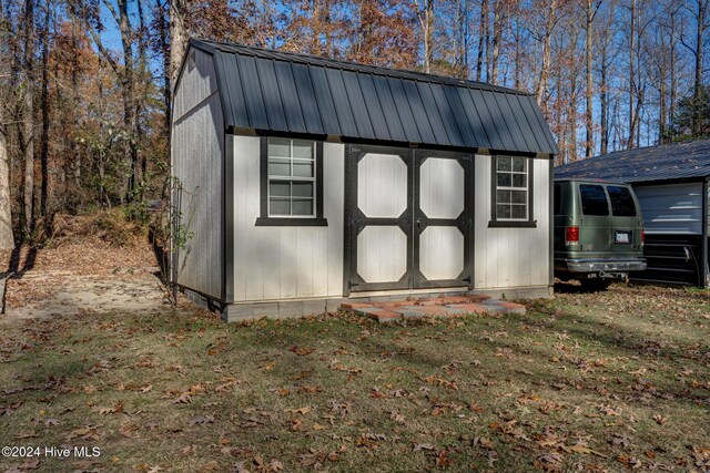 view of outbuilding featuring a lawn