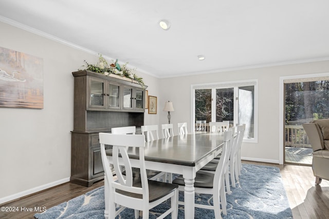 dining room with dark hardwood / wood-style flooring and ornamental molding