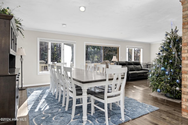 dining area with dark hardwood / wood-style floors and ornamental molding