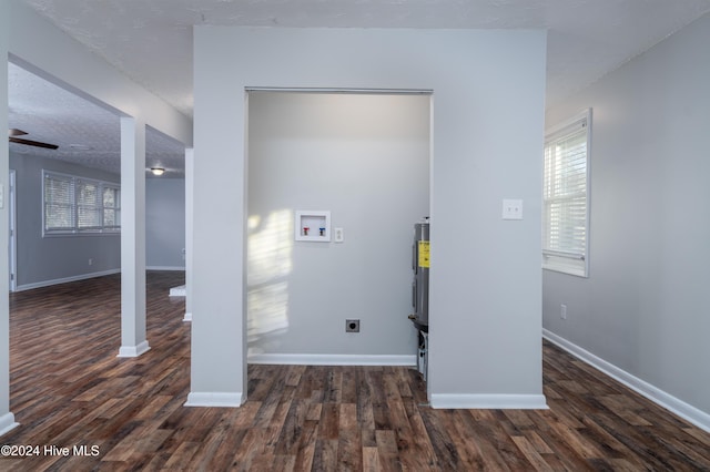 washroom with washer hookup, a textured ceiling, dark wood-type flooring, and electric dryer hookup