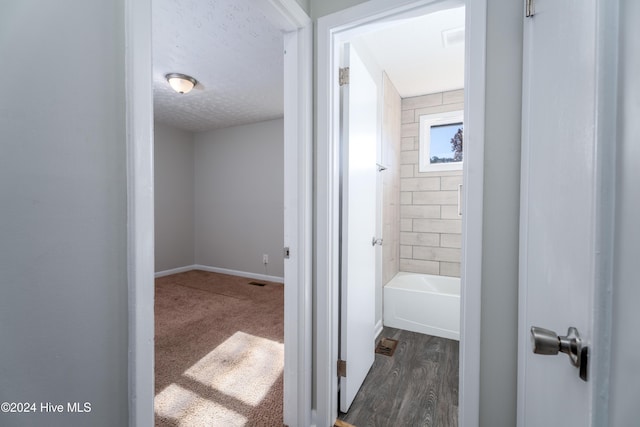 bathroom featuring hardwood / wood-style flooring and a textured ceiling