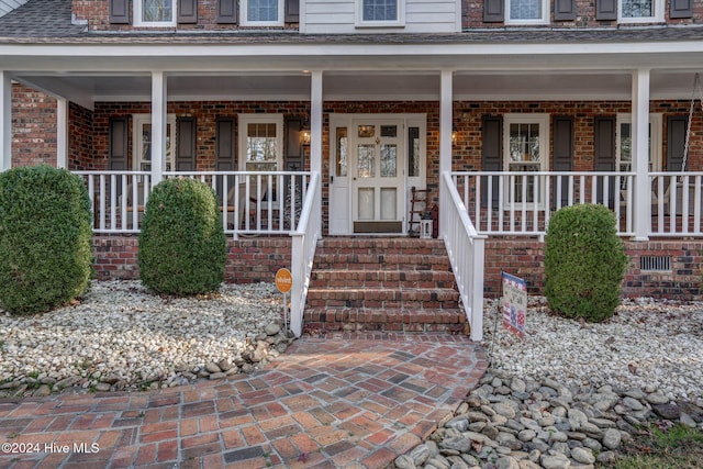 property entrance with covered porch