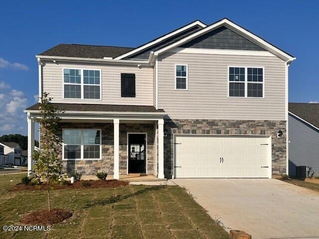 craftsman inspired home with a front yard and a garage