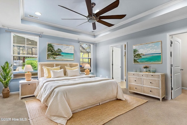 bedroom featuring light carpet, crown molding, a raised ceiling, and ceiling fan