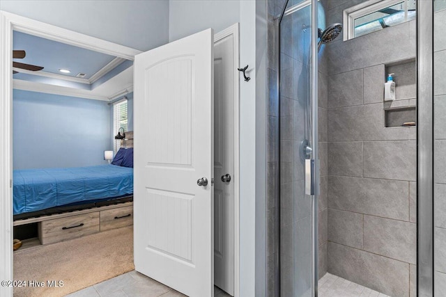 bathroom featuring a tray ceiling, a shower with door, tile patterned floors, and crown molding