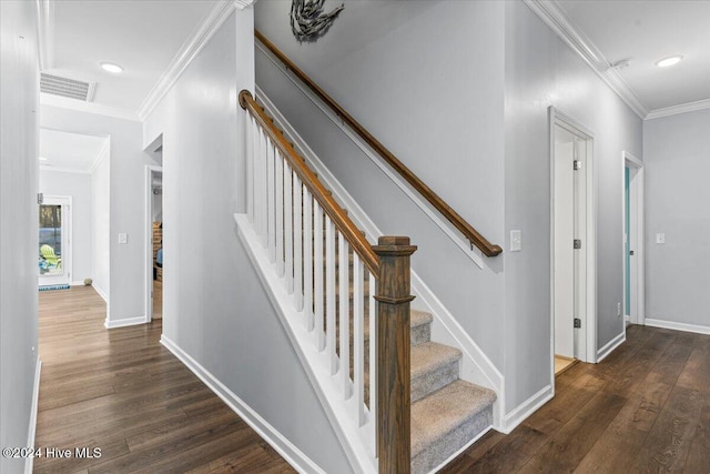 stairway with hardwood / wood-style flooring and crown molding