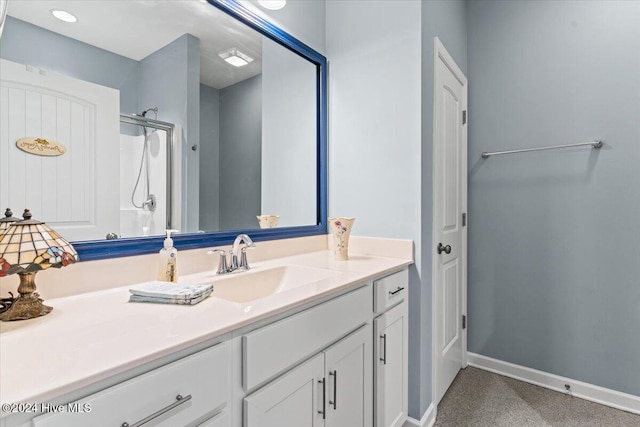 bathroom with walk in shower and vanity