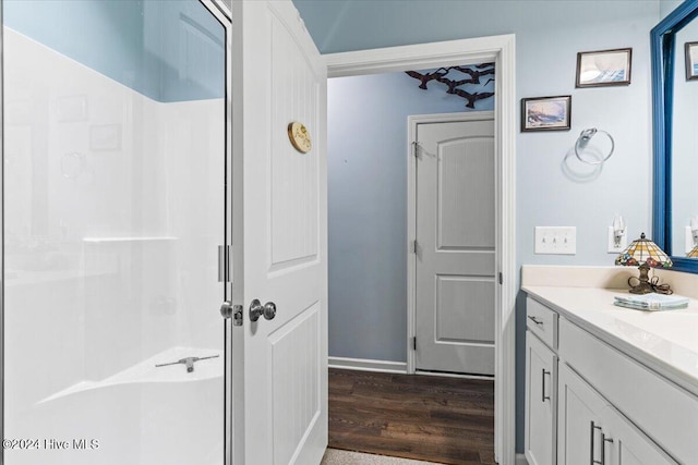 bathroom featuring a shower, wood-type flooring, and vanity