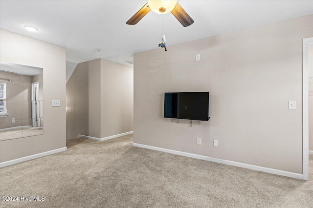 unfurnished living room with light carpet and ceiling fan