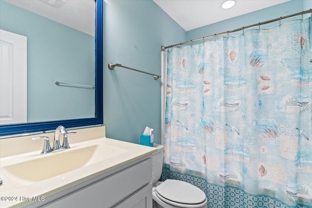 full bathroom with vanity, toilet, and shower / tub combo with curtain