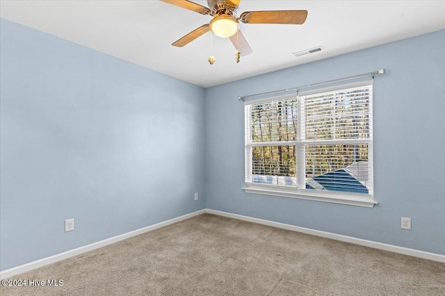 carpeted empty room featuring ceiling fan