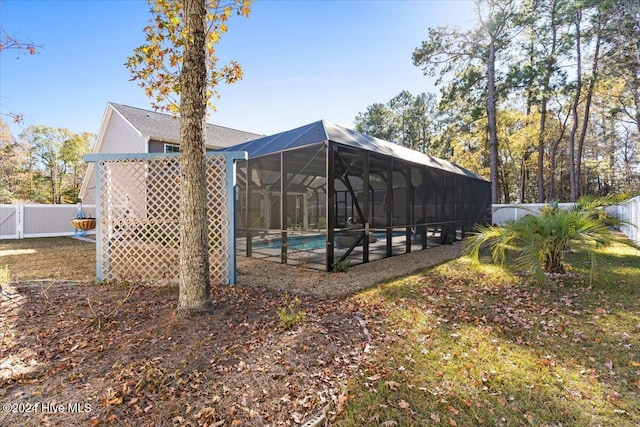 view of yard featuring a fenced in pool and a lanai