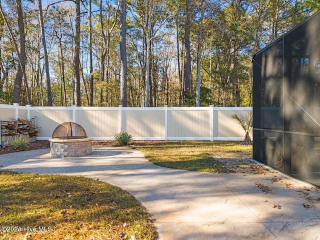 exterior space with a fire pit and a patio