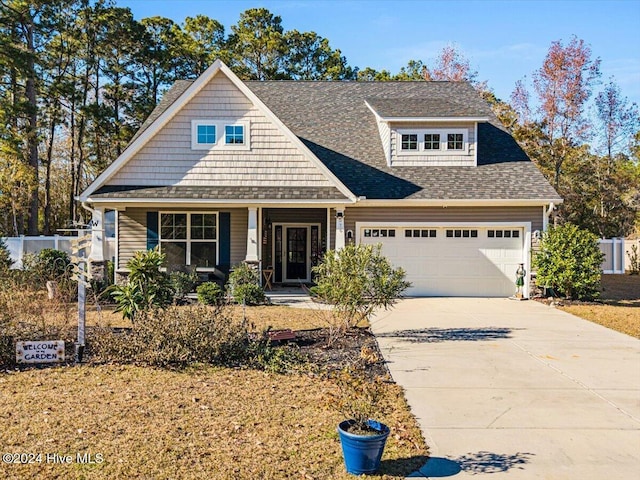 craftsman inspired home featuring a garage and covered porch