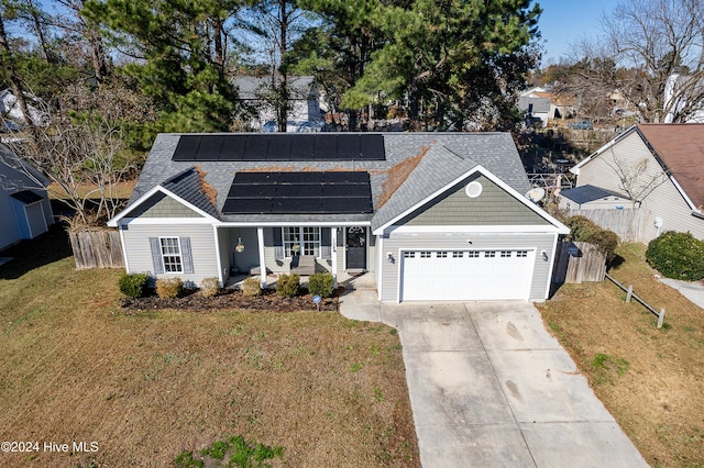 front facade with covered porch, solar panels, a garage, and a front lawn