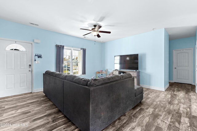 living room featuring hardwood / wood-style floors and ceiling fan