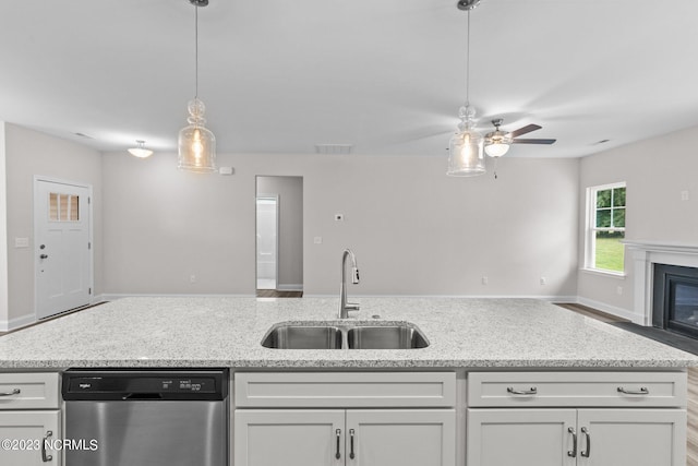 kitchen with white cabinets, stainless steel dishwasher, and sink