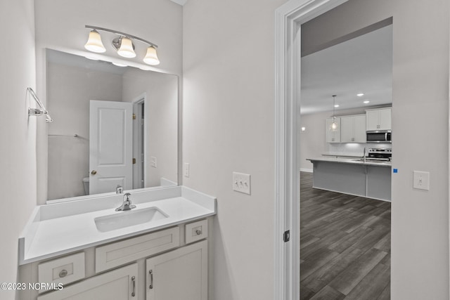 bathroom with tasteful backsplash, vanity, and wood-type flooring