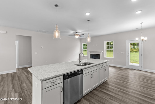 kitchen with white cabinetry, dishwasher, sink, an island with sink, and ceiling fan with notable chandelier