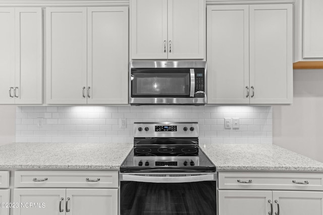 kitchen with backsplash, white cabinetry, light stone counters, and appliances with stainless steel finishes