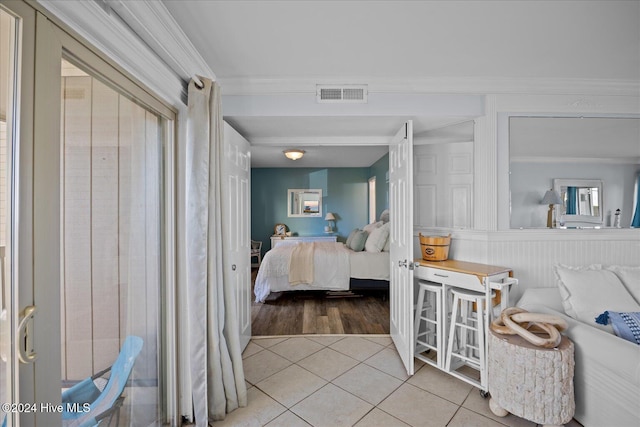 bedroom featuring tile patterned floors and crown molding