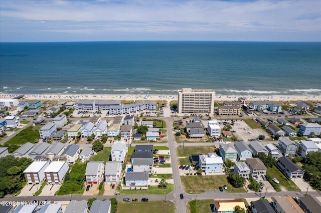 birds eye view of property with a water view and a view of the beach