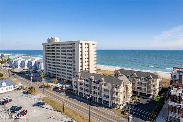 birds eye view of property featuring a water view and a beach view