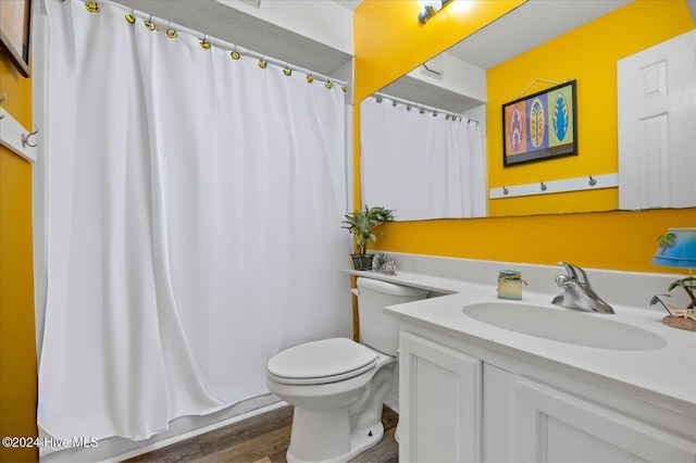 bathroom with hardwood / wood-style flooring, vanity, toilet, and a shower with curtain