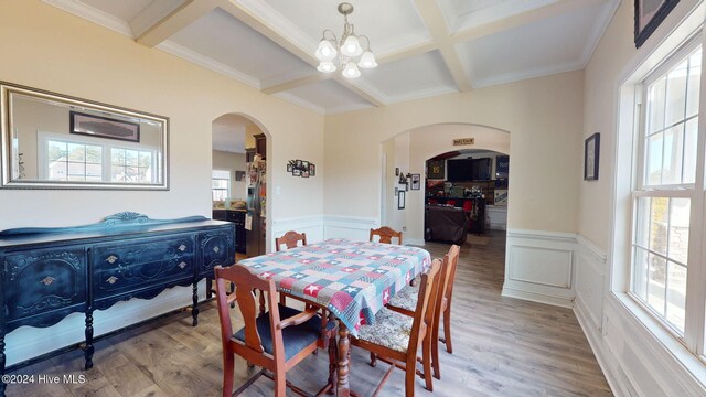 dining space featuring beamed ceiling, visible vents, and coffered ceiling