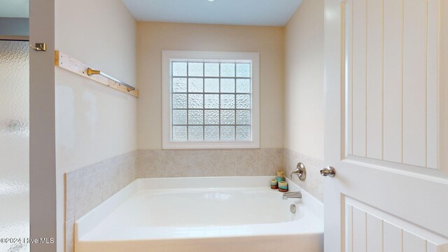 full bathroom with a sink, a stall shower, and double vanity