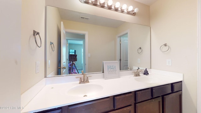 bathroom featuring double vanity, visible vents, and a sink