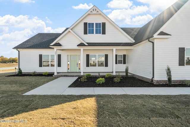 view of front of house with a porch and a front yard