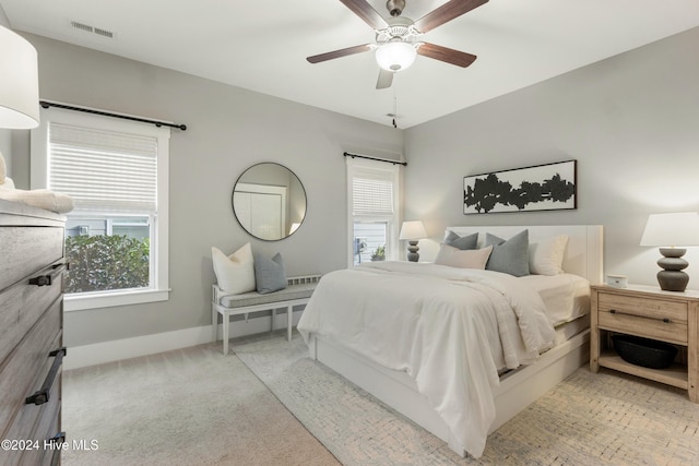 bedroom featuring light colored carpet and ceiling fan