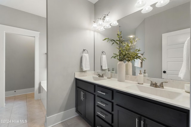 bathroom with tile patterned flooring, vanity, and a tub