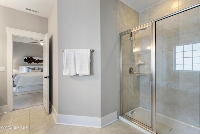 bathroom with tile patterned floors, ceiling fan, and walk in shower