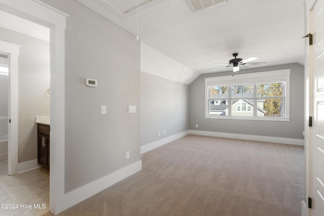 bonus room with light carpet, ceiling fan, and vaulted ceiling