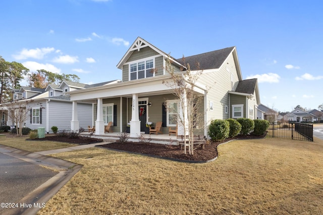 view of front of property featuring a front yard and covered porch