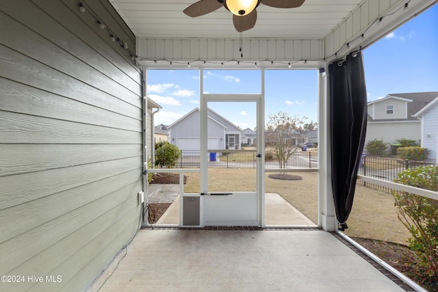 unfurnished sunroom with ceiling fan