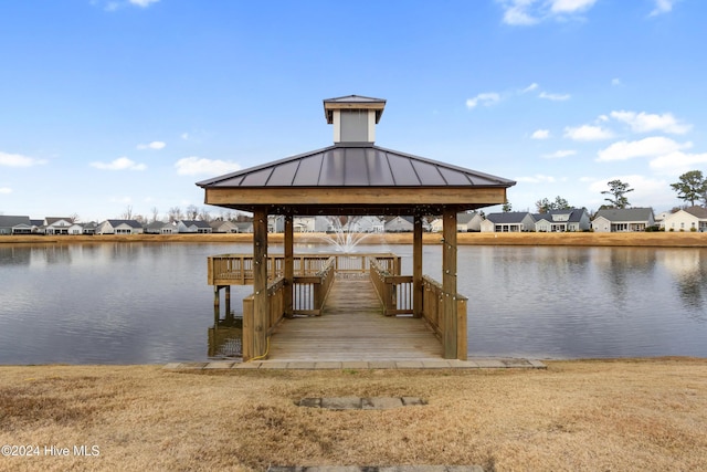 view of dock with a gazebo and a water view