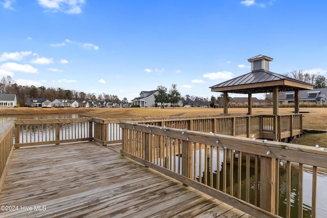 view of dock featuring a gazebo and a water view